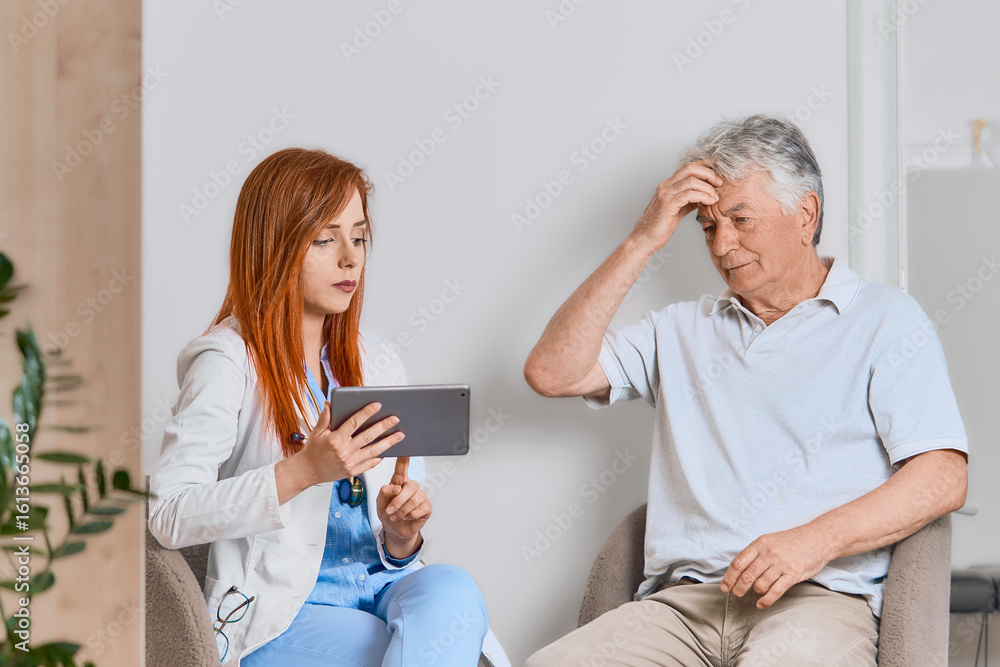 Obraz premium Concerned doctor discussing healthcare options with an older man patient during a professional consultation in a clinic. 