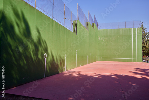 Fronton. A fronton court for playing pelota. It's located in the sports area of a small town.