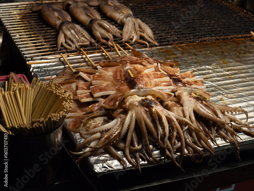 Abundant Grilled Squid Skewers on a Market Grill