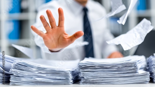 A blurred face man in white shirt with striped tie gestures stop amid chaotic office papers,