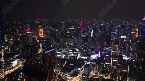 Wallpaper Mural Cinematic night timelapse of Kuala Lumpur skyline with glowing skyscrapers, traffic, and iconic towers. Modern city lights and urban landscape in Malaysia. Torontodigital.ca