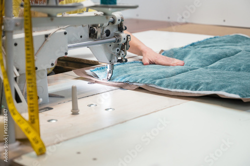 Tailor stitching furniture upholstery elements with the sewing machine. Furniture production