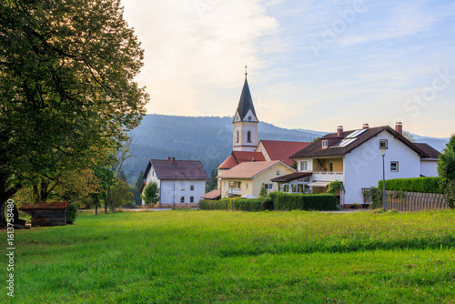 Parish church of the Sacred Heart of Jesus in village Ludwigsthal (Lindberg) with Bavarian Forest National Park mountain panorama, Germany