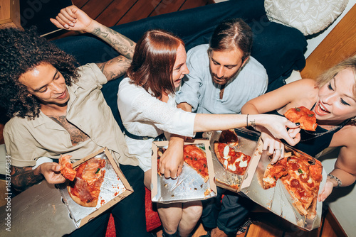 Friends enjoying pizza during social gathering at home