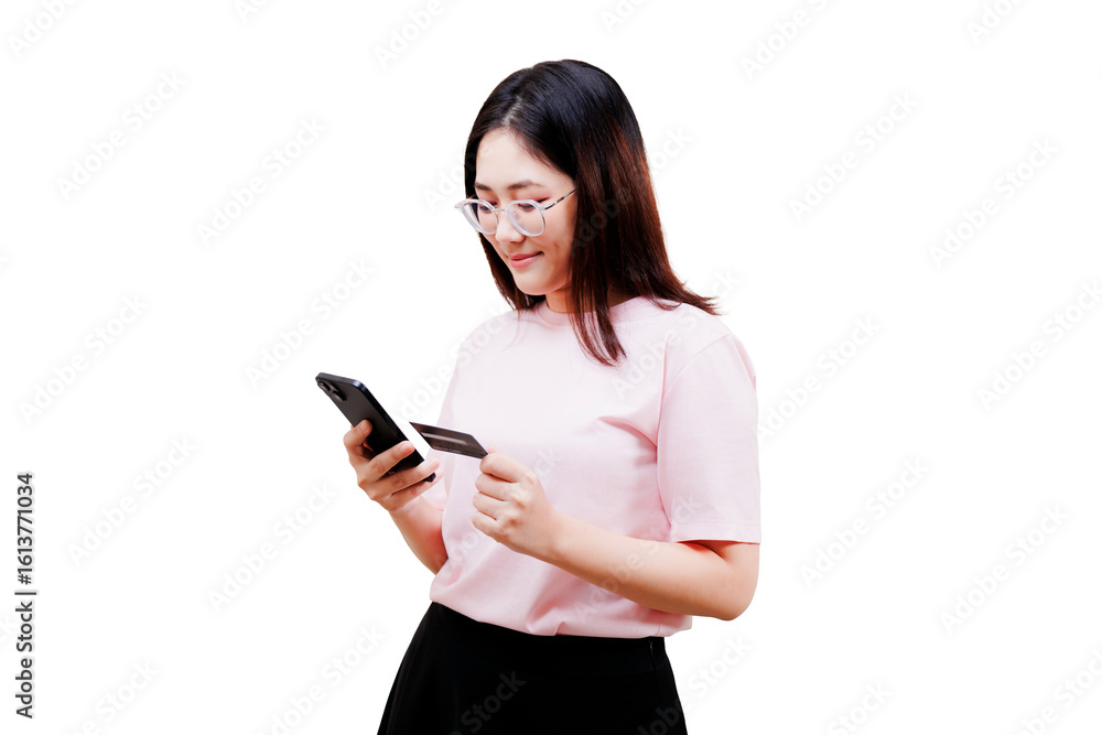 Asian young beautiful woman wearing glasses and a pink shirt holds a smartphone and a credit card, appearing to make an online payment or transaction. Asian young beautiful woman wearing glasses and a pink shirt holds a smartphone and a credit card, appearing to make an online payment or transaction.