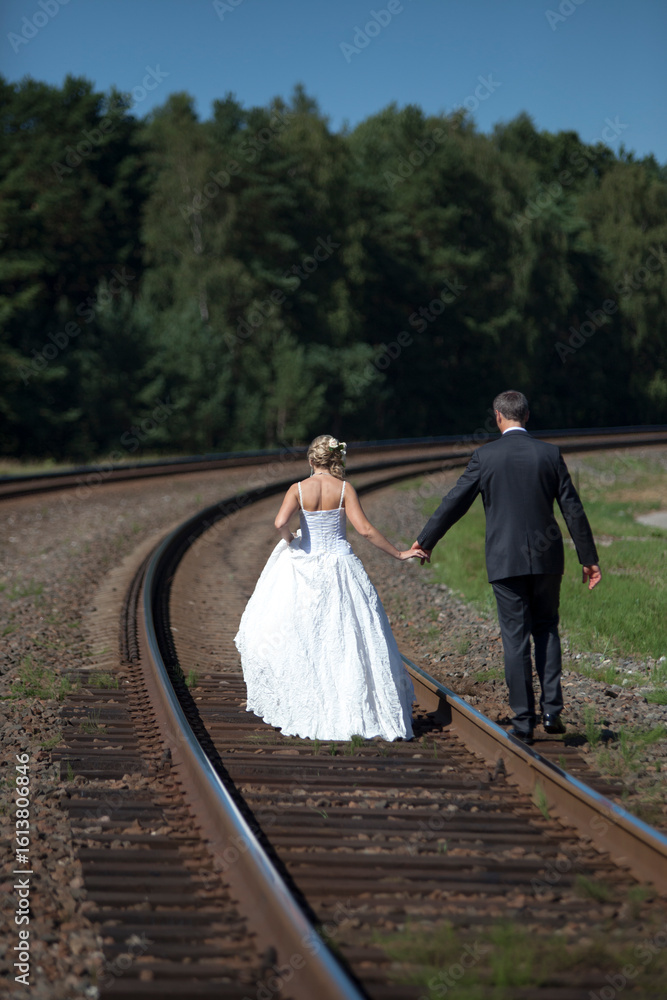 Fototapeta premium bride and groom walking in the park