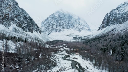 Wallpaper Mural Aerial view of snow-dusted mountains and a winding river, with small cabins nestled amongst frosted trees, Republic of Bashkortostan, Russia. Torontodigital.ca