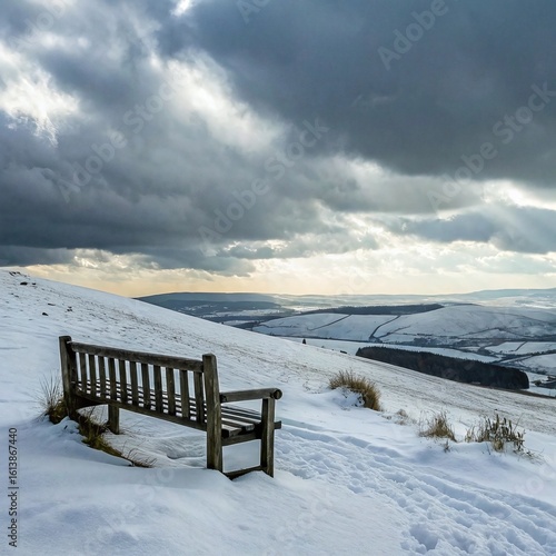 Wallpaper Mural Wooden bench on a snowy hill overlooking vast mountain ranges under a dramatic winter sky, evoking solitude and serenity. Torontodigital.ca