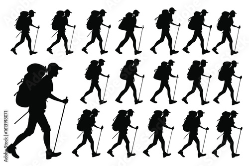 Silhouette of hikers with backpacks and trekking poles in motion