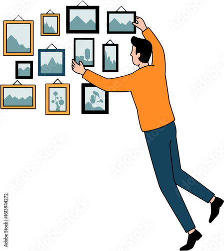 A person arranging picture frames on wall.