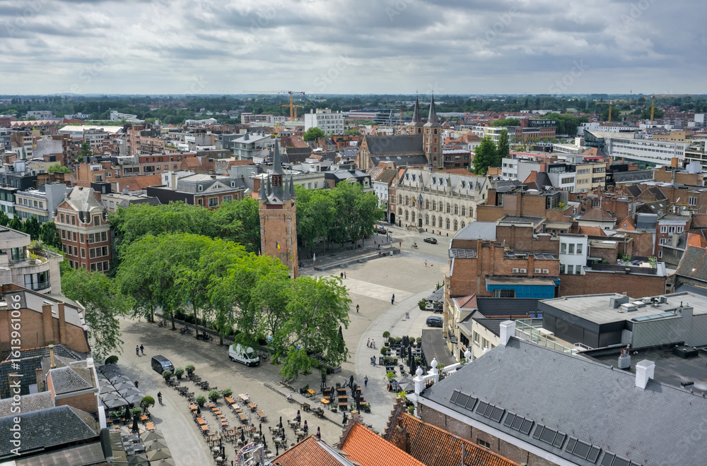 Obraz premium An expansive aerial view of Kortrijk's historic Grote Markt, featuring its distinctive belfry and surrounding urban landscape.