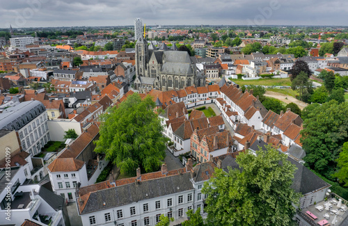 An expansive aerial view of Kortrijk's historic city center, dominated by the majestic Onze-Lieve-Vrouwekerk.
