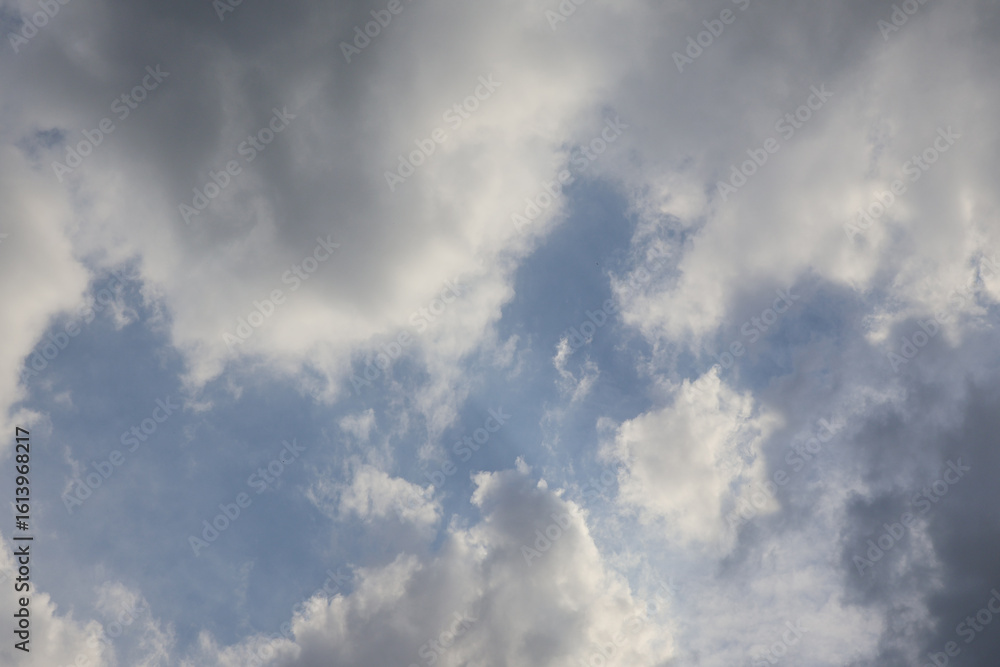 Fototapeta premium Cloudy sky reveals hints of blue on a late afternoon