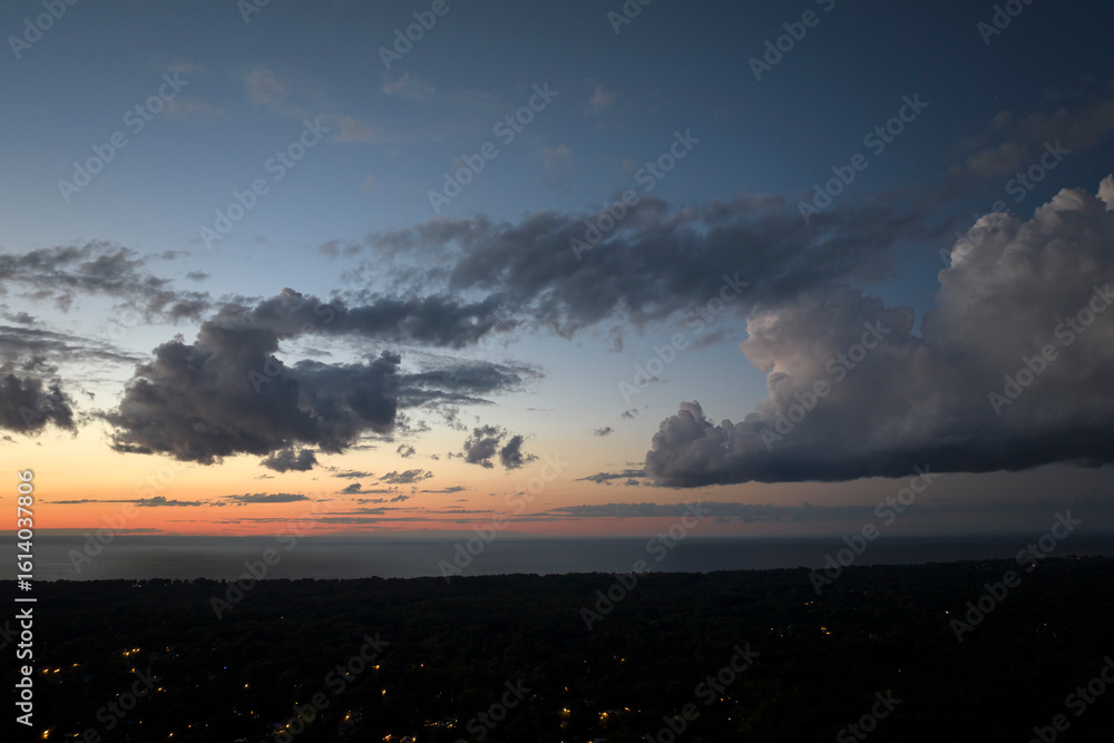 Obraz premium Amazing evening skyscape. Sunset sky with bright colorful clouds over dark landscape