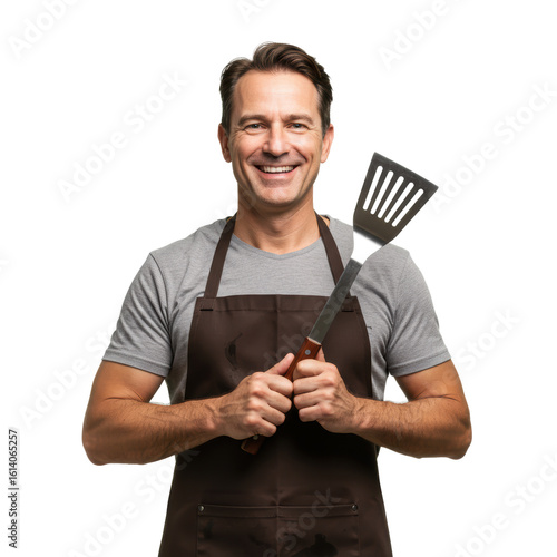 A happy chef is holding a spatula, ready to grill some delicious food.