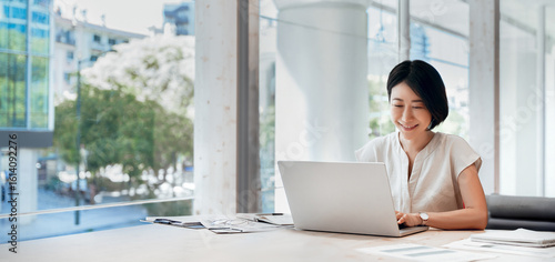 Free Download Middle-aged woman using computer technology for financial marketing work online. Mature Asian professional businesswoman analyst working concentrated on laptop pc at desk in office. Banner, copy space - GFXLoad