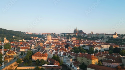 Wallpaper Mural Experience the serene beauty of Prague as the sun rises. Soar above the Vltava River, capturing stunning views of Prague Castle and Charles Bridge in the early morning light. Torontodigital.ca
