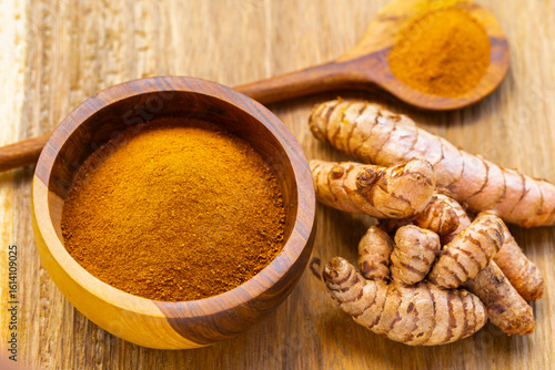 Fresh and Ground Turmeric on Rustic Background – Natural Health and Culinary Ingredient