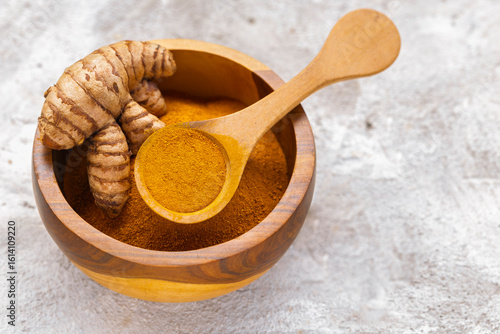 Fresh and Ground Turmeric on Rustic Background – Natural Health and Culinary Ingredient