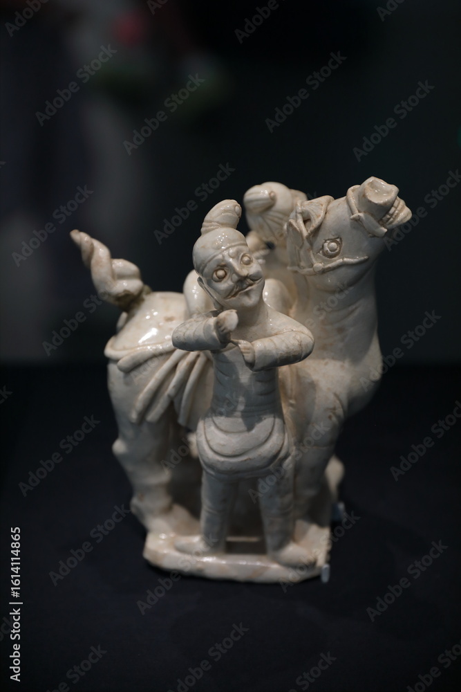 Blush white glazed figurine of Hu people leading a horse Blush white glazed figurine of Hu people leading a horse