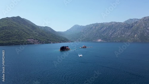 4K Aerial Drone Shot of Risan Bay and Gulf of Kotor, Montenegro, Featuring Ships, Yachts, and Mountain Peaks Beyond the Bay on a Clear Sunny Day
