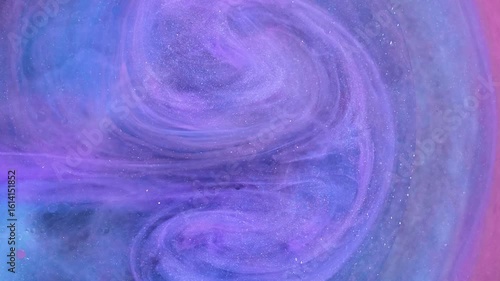 Creating mesmerizing patterns with drops of acrylic paint in oil on a vibrant canvas