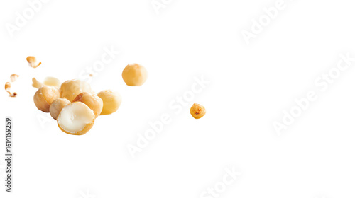 A pile of macadamia nuts, some whole and some cracked open, isolated on transparent background