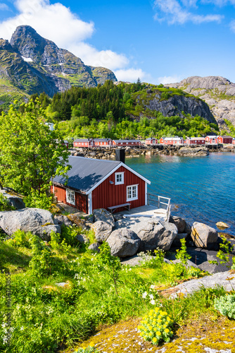 Red traditional type houses (Rorbu) used by fishermen's in Nusfjord village port on Flakstadoya island in summer, Lofoten Islands, Norway
