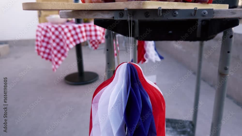 hilean Independence Day video: Copihue paper decoration then camera reveals anticuchos on grill and decorated terrace with traditional foods and chupalla