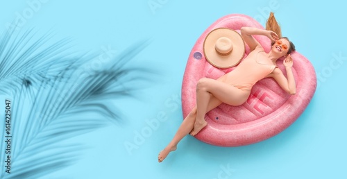 Happy woman in swimsuit lyi...
