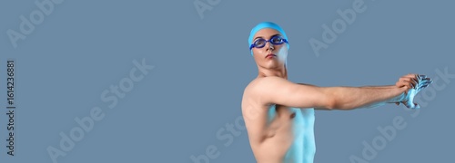 Male swimmer stretching on ...
