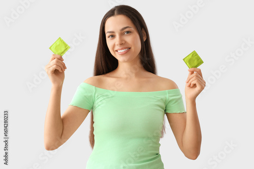 Young woman with condoms on...