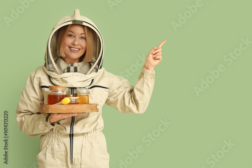 Female beekeeper with jars ...