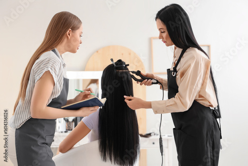 Female hairdresser with ass...