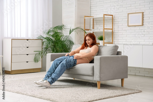 Young woman trying to put t...