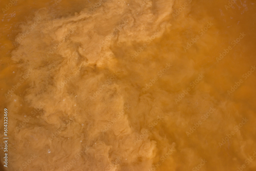 Obraz premium Sand raised from the bottom of a reservoir, muddy water in a river