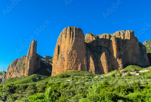 Bild auf Leinwand Mallos de Riglos Spain: united vertical red conglomerate cliffs and rock towers
