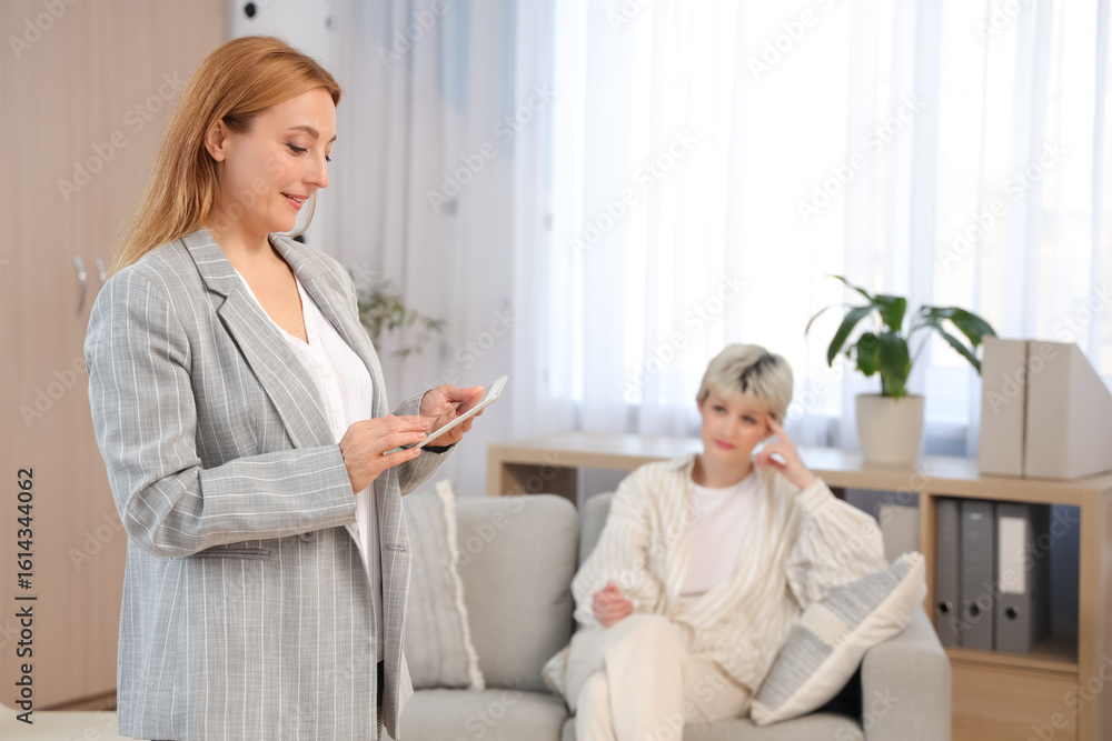 Female adolescent psychologist with tablet computer in office Female adolescent psychologist with tablet computer in office