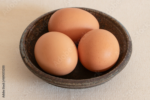 Three Pasture Raised Chicken Eggs in a Bowl