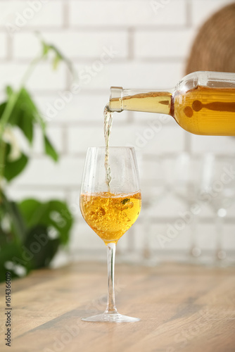Pouring of white wine from ...