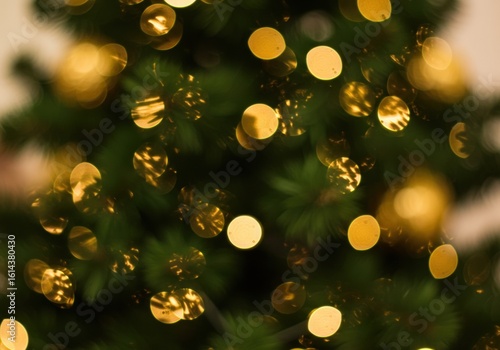 Close-up of a Christmas tree with stunning, golden bokeh lights shining.