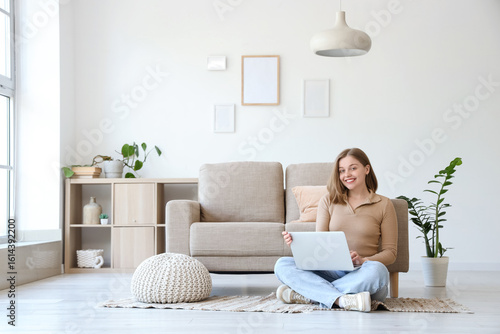 Young woman using laptop on...