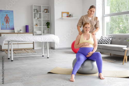 Female therapist massaging ...
