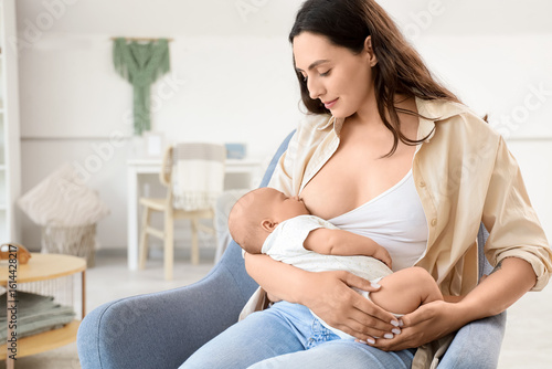 Young mother breastfeeding ...