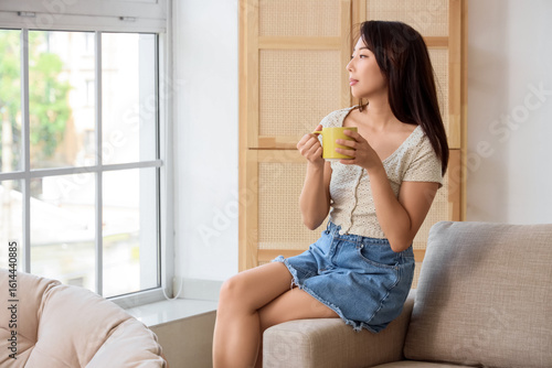 Young Asian woman with cup ...