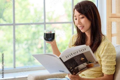 Young Asian woman with cup ...