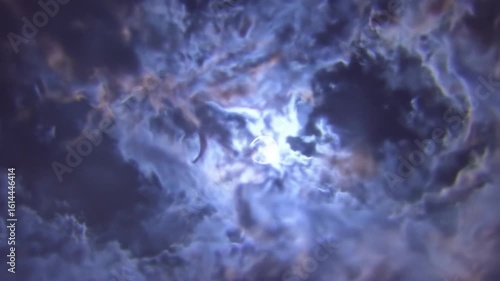 Dramatic Night Sky with Full Moon Surrounded by Swirling Blue and White Clouds