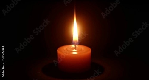 calmly flickering candle flame in darkness creating a peaceful ambiance