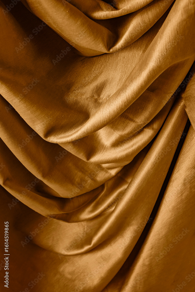 Obraz premium Golden satin silk with crumpled abstract texture background. Material textile surface. Copy space