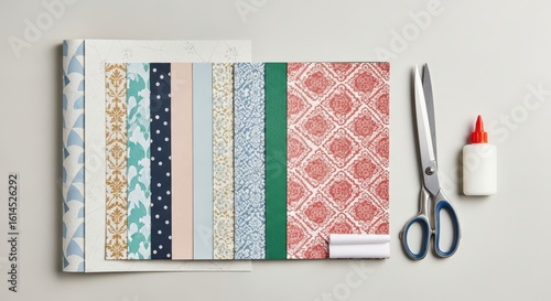 Assortment of colorful wallpaper samples with crafting tools